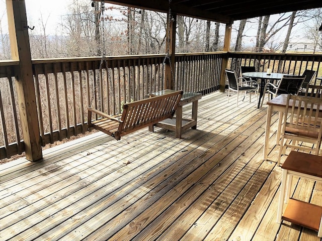 wooden terrace featuring outdoor dining space