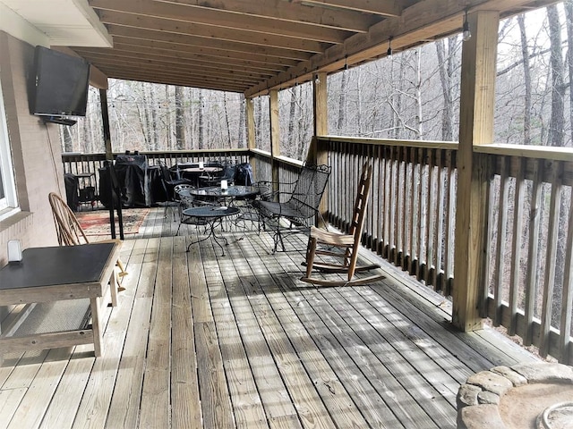 wooden terrace with outdoor dining space