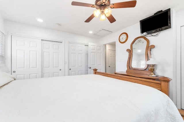 unfurnished bedroom featuring ceiling fan, recessed lighting, attic access, and multiple closets