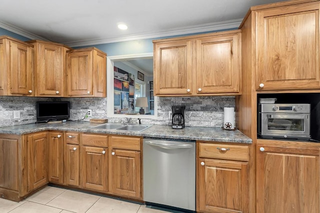 kitchen featuring brown cabinets, stainless steel dishwasher, ornamental molding, light tile patterned flooring, and a sink