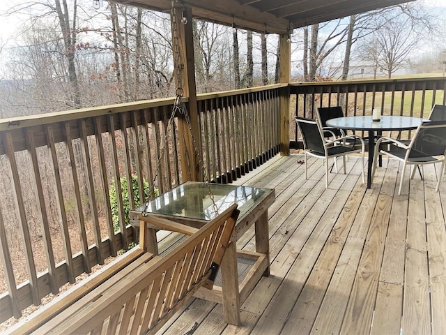 wooden terrace featuring outdoor dining area