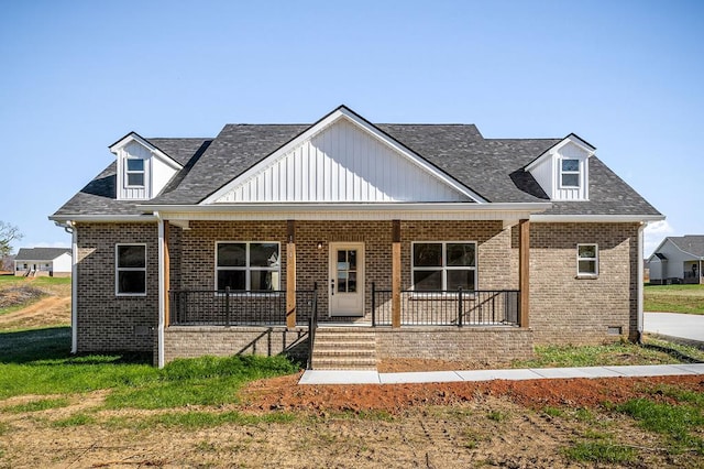 view of front facade with a porch and brick siding