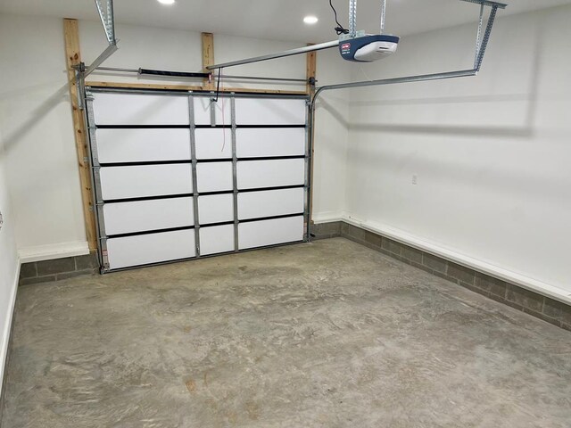 garage with recessed lighting and a garage door opener