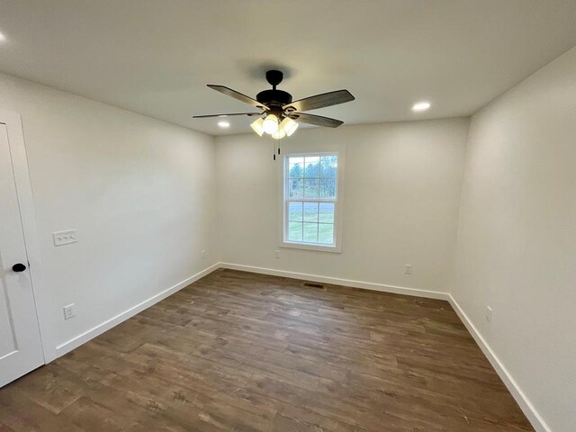 empty room featuring a ceiling fan, baseboards, dark wood-type flooring, and recessed lighting