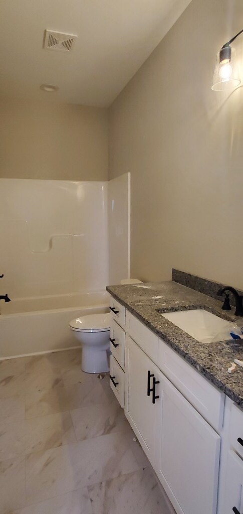 full bath featuring toilet, vanity, visible vents, marble finish floor, and shower / bathing tub combination