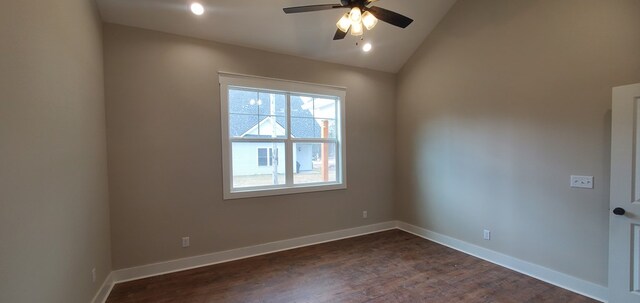 unfurnished room with lofted ceiling, ceiling fan, baseboards, and dark wood-style flooring