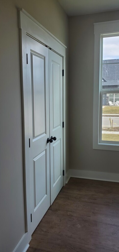 interior space featuring dark wood-style floors and baseboards