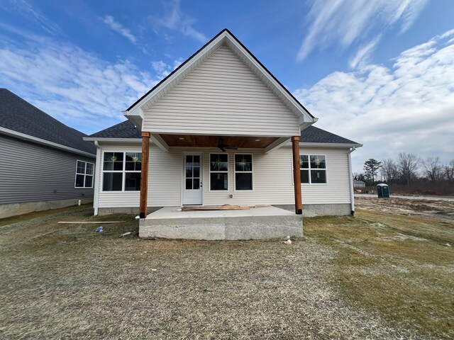 rear view of house featuring a patio area, ceiling fan, and roof with shingles