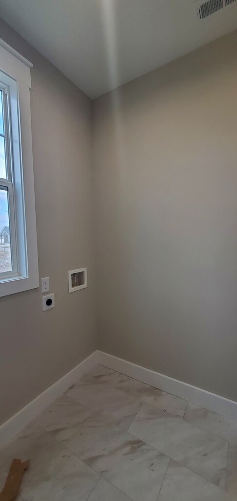 clothes washing area featuring laundry area, visible vents, baseboards, hookup for a washing machine, and electric dryer hookup