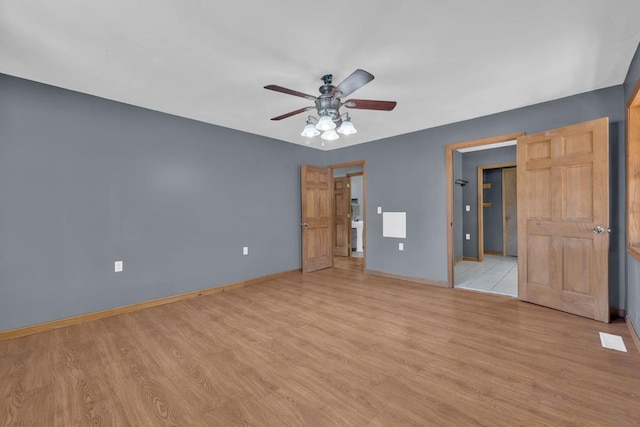 unfurnished bedroom with visible vents, ceiling fan, light wood-style flooring, and baseboards