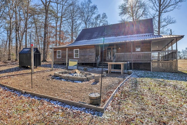 back of property with covered porch and metal roof