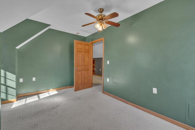 empty room with carpet floors, baseboards, and a ceiling fan