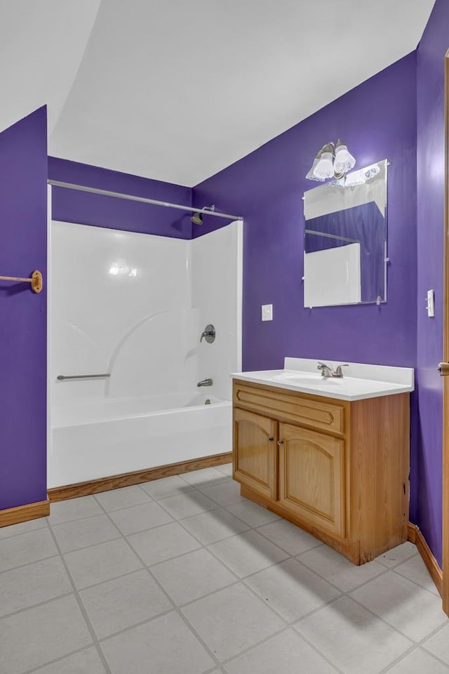 full bath featuring vanity, baseboards, and bathing tub / shower combination