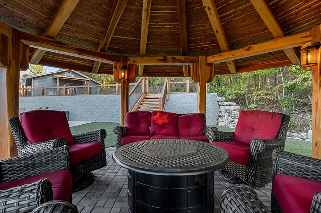 view of patio with stairs, outdoor lounge area, and a gazebo