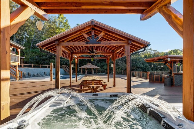 view of patio with fence, a deck, and a gazebo