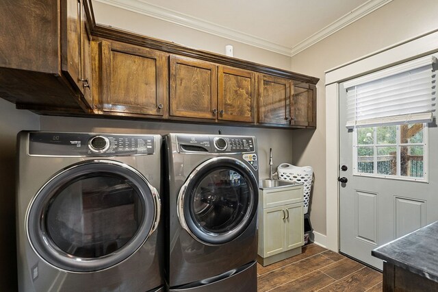 washroom featuring cabinet space, ornamental molding, wood tiled floor, separate washer and dryer, and baseboards