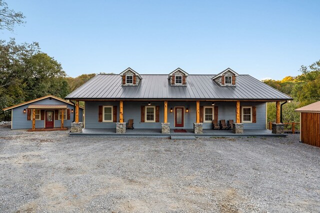 view of front of property with covered porch, metal roof, and a standing seam roof