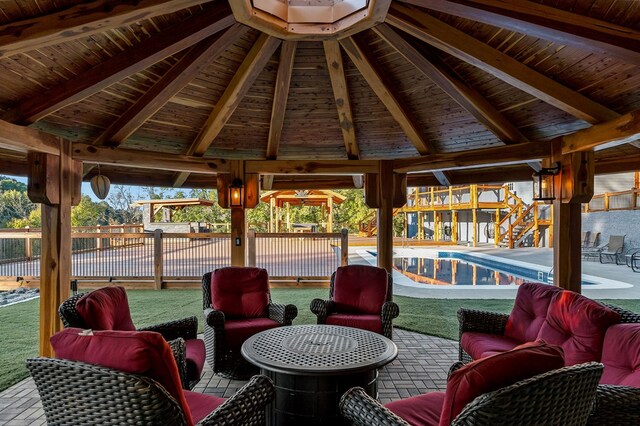 sunroom featuring wooden ceiling, a healthy amount of sunlight, and vaulted ceiling with beams