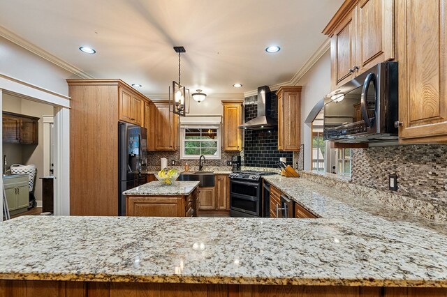 kitchen featuring wall chimney range hood, decorative light fixtures, a peninsula, stainless steel range oven, and black fridge