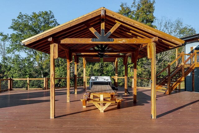 wooden terrace with ceiling fan and a gazebo