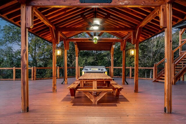 wooden deck with ceiling fan, a grill, and a gazebo