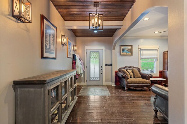 entryway with arched walkways, wood ceiling, baseboards, and dark wood-style flooring