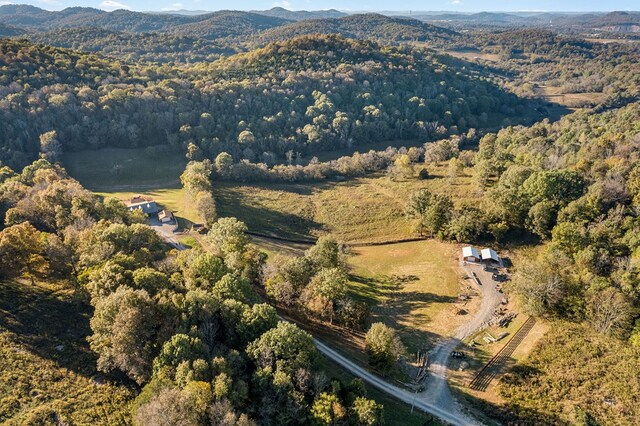 drone / aerial view with a forest view and a mountain view