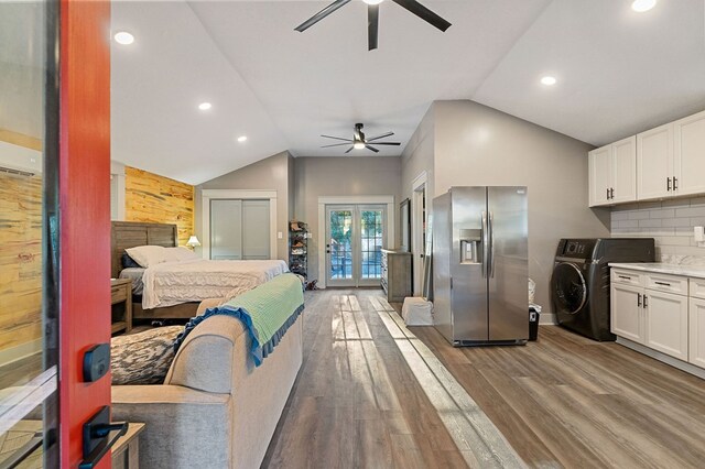 kitchen featuring washer / dryer, white cabinets, light countertops, and stainless steel fridge with ice dispenser