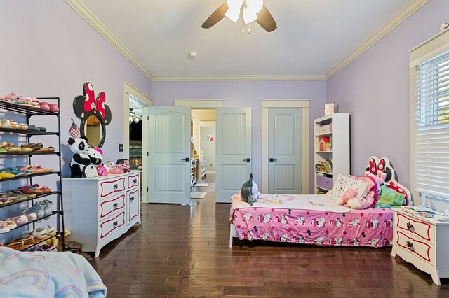 bedroom featuring dark wood-style floors, ornamental molding, and a ceiling fan