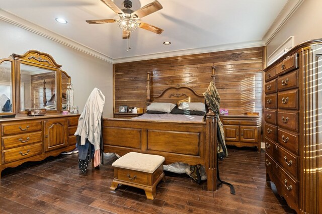 bedroom featuring dark wood finished floors, crown molding, and recessed lighting