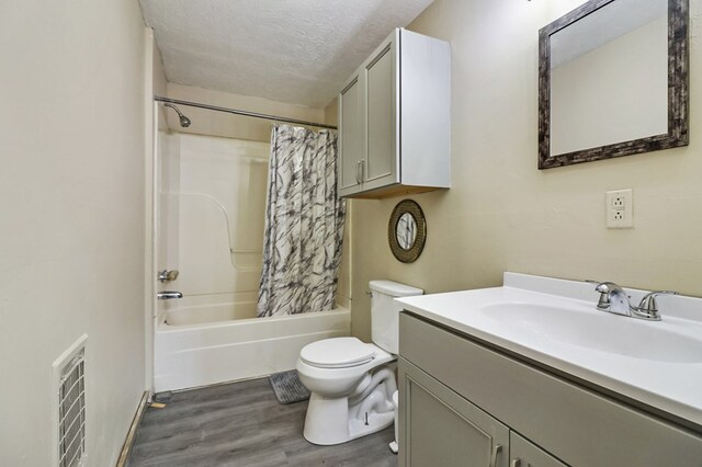 full bathroom featuring toilet, shower / bath combo with shower curtain, vanity, a textured ceiling, and wood finished floors