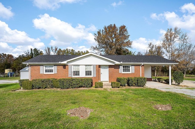 ranch-style house with a carport, driveway, brick siding, and a front yard