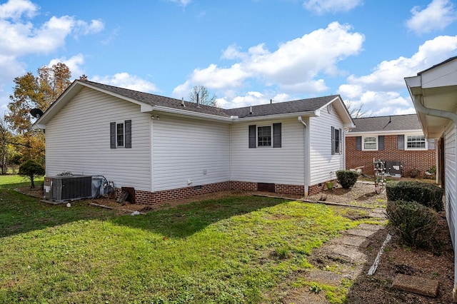 rear view of house with crawl space, a lawn, and central AC