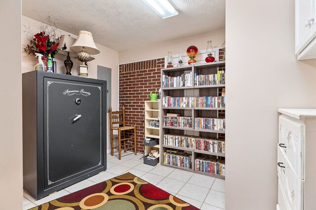 interior space featuring a textured ceiling and light tile patterned flooring