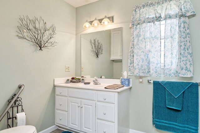 bathroom featuring baseboards and vanity