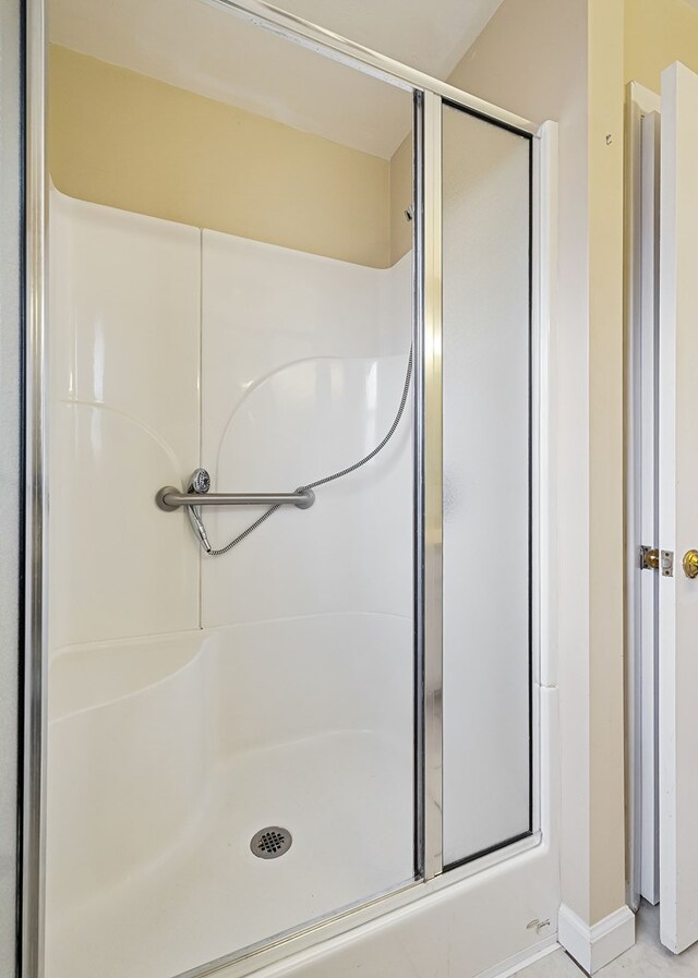 full bathroom featuring a shower with door