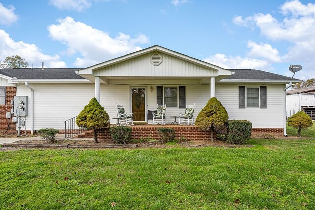 ranch-style house with covered porch and a front lawn