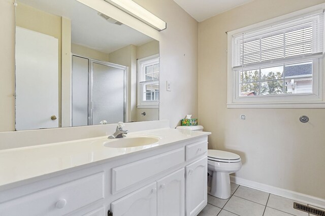 bathroom featuring plenty of natural light, vanity, visible vents, and tile patterned floors