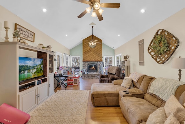 living room featuring light wood finished floors, recessed lighting, a fireplace, and ceiling fan