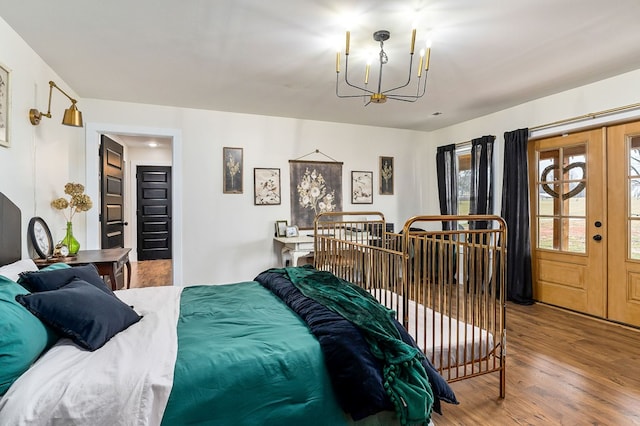 bedroom featuring a notable chandelier and wood finished floors