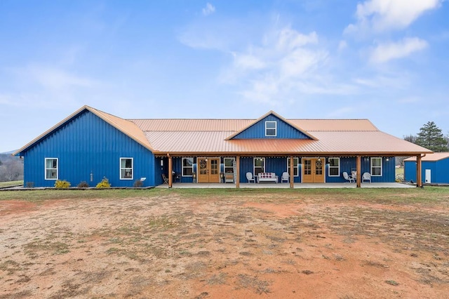 exterior space with metal roof and french doors