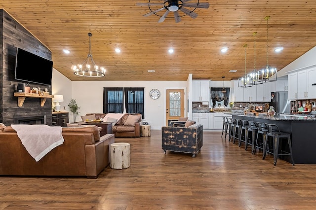 living room with dark wood-style floors, a fireplace, recessed lighting, high vaulted ceiling, and wooden ceiling