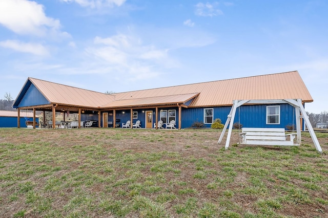 view of front of house with metal roof and a front yard