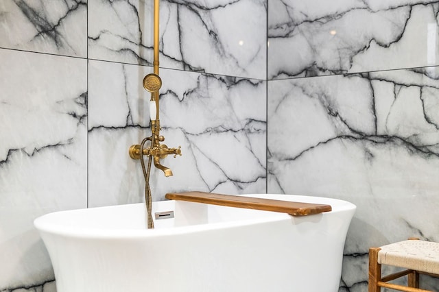 full bath featuring a freestanding bath and a sink