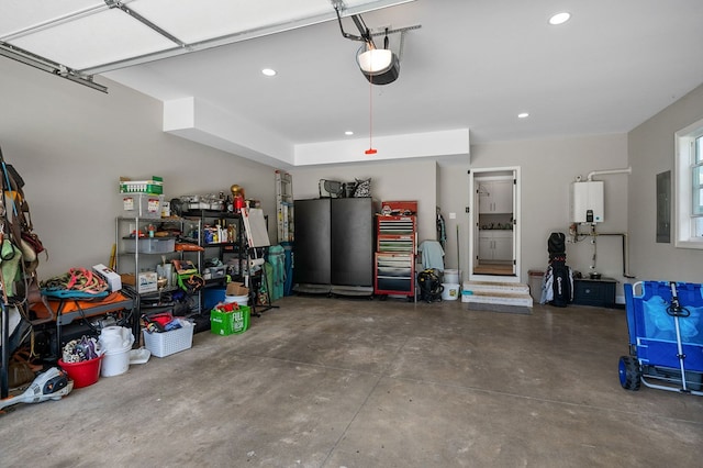 garage featuring water heater, a garage door opener, electric panel, and recessed lighting