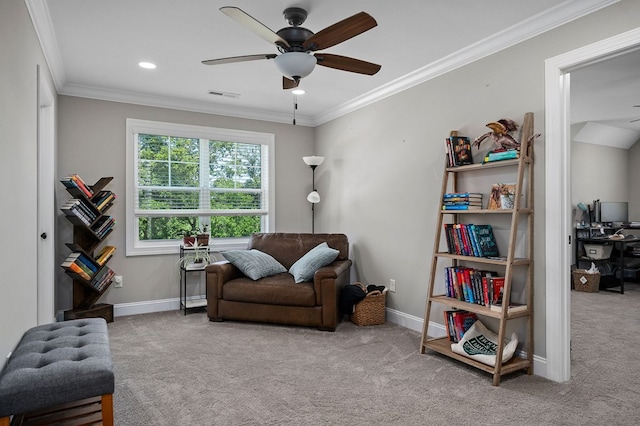 sitting room with baseboards, visible vents, a ceiling fan, crown molding, and carpet flooring