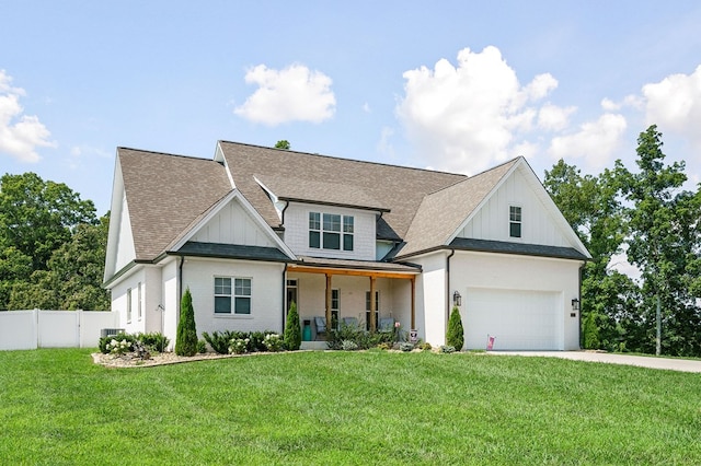 modern farmhouse style home with covered porch, a front lawn, board and batten siding, and fence