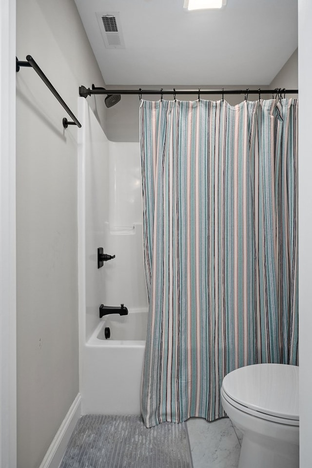 bathroom featuring toilet, visible vents, baseboards, marble finish floor, and shower / bath combination with curtain