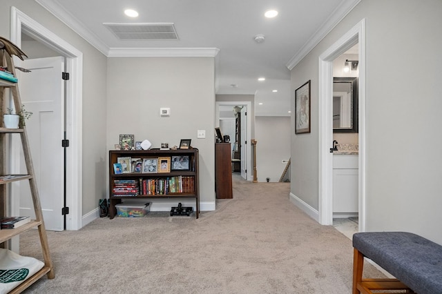 corridor with visible vents, crown molding, light carpet, and an upstairs landing