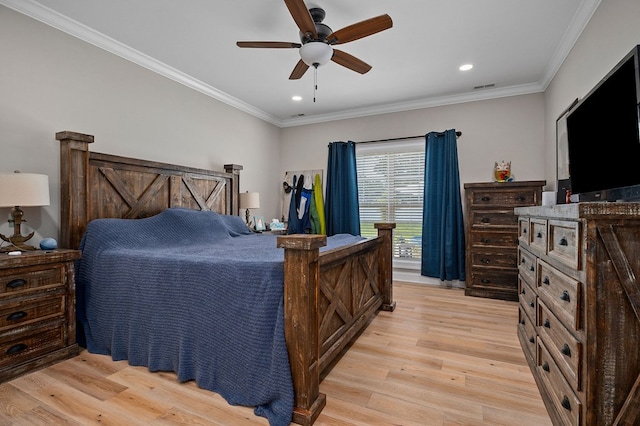 bedroom featuring crown molding, visible vents, and light wood-style floors